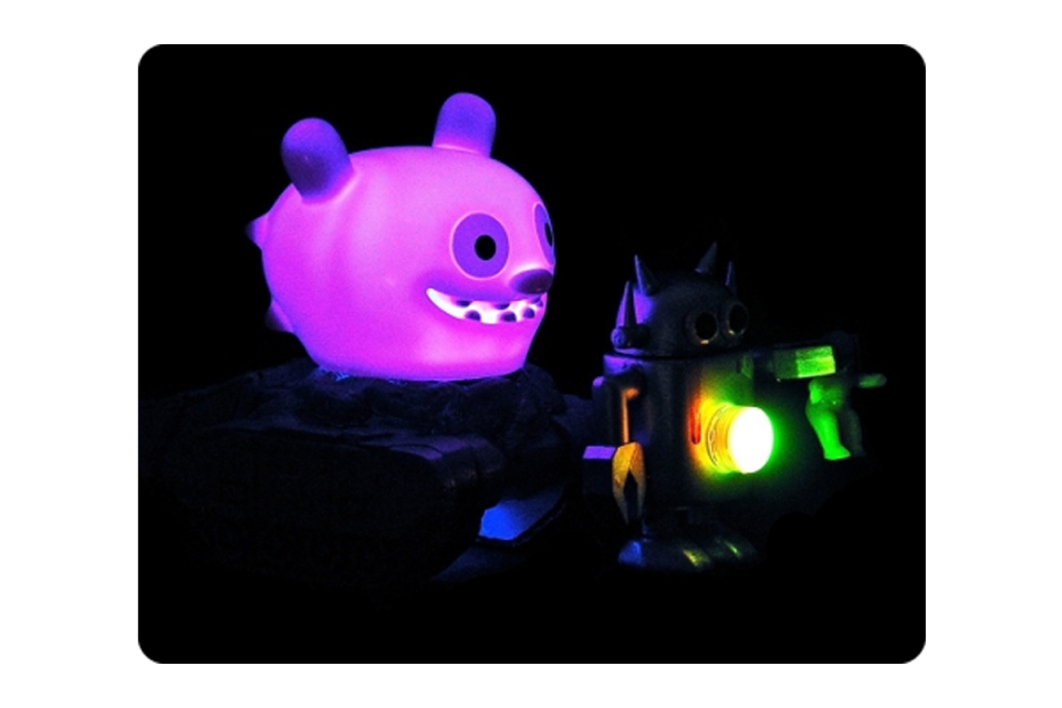 Glow in the dark animal head and other glowing images on a black background